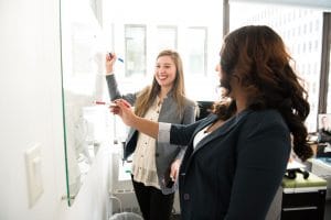 business woman working together on whiteboard